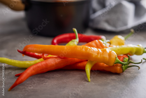 Colorful Assortment of Fresh Chili Peppers on Kitchen Countertop Ready for Spicy Cooking