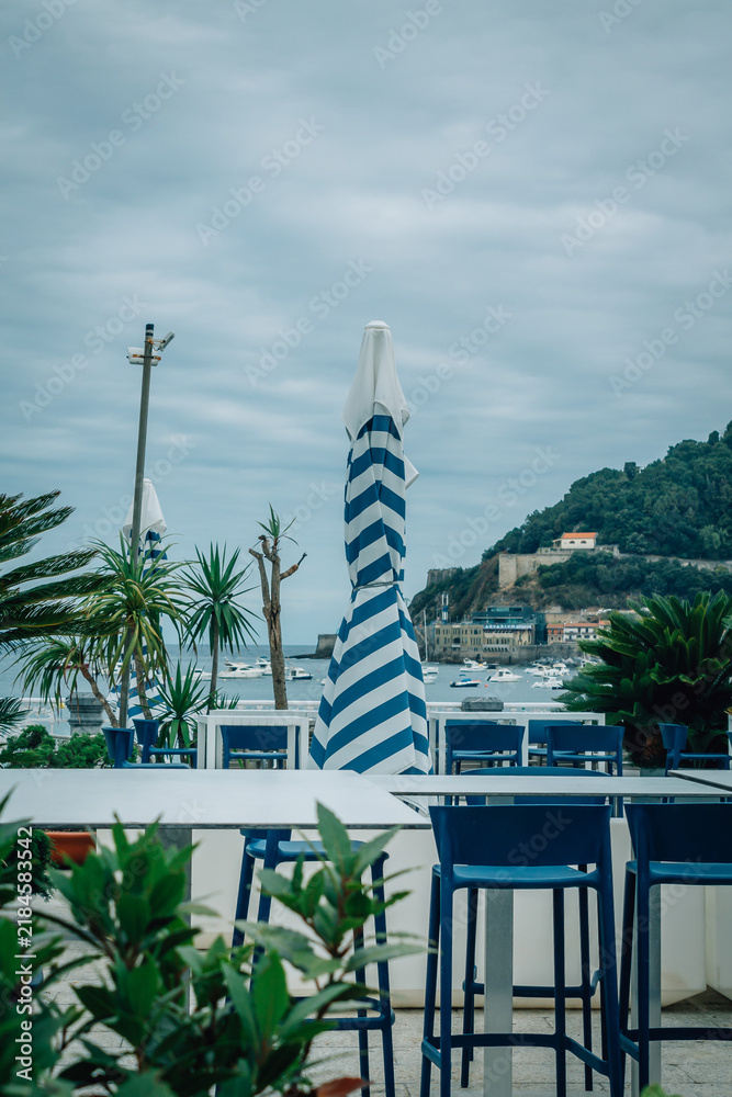 Obraz premium outdoor restaurant overlooking La Concha Bay in San Sebastian, Basque Country, Spain