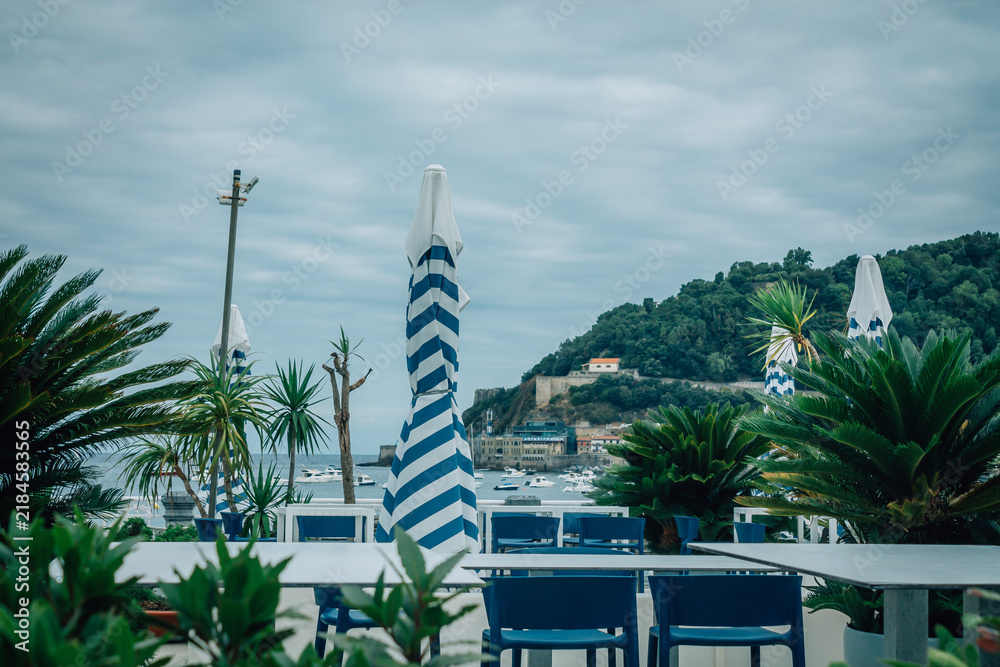 Obraz premium outdoor restaurant overlooking La Concha Bay in San Sebastian, Basque Country, Spain