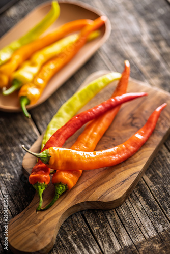 Fresh Red and Orange Chili Peppers on Wooden Board Close-Up Spicy Ingredient for Cooking