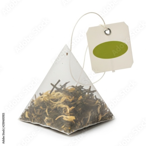 Tea bag with tag floating above isolated on white background