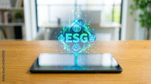 ESG reporting standards concept with digital tablet on wooden table in modern office environment showing sustainability and governance