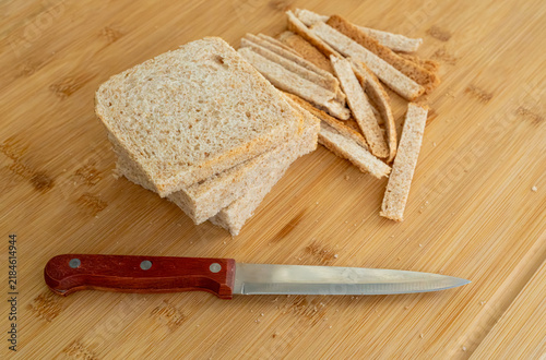 Cutting the crusts off, crustless bread for sandwiches closeup