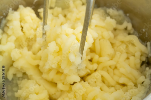 Photography Making mash potato with hand potato masher