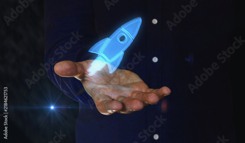 Startup rocket launch symbol over hand