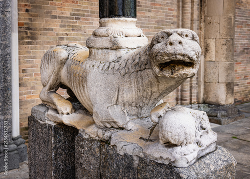 Stone lion statue supporting column in Piazza Broletto, Lodi