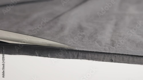 Using scissors to cut black cloth