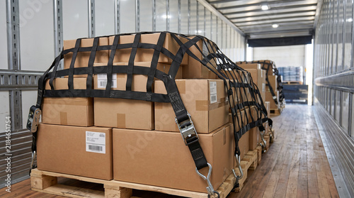 Cargo boxes secured with a net inside a delivery truck  