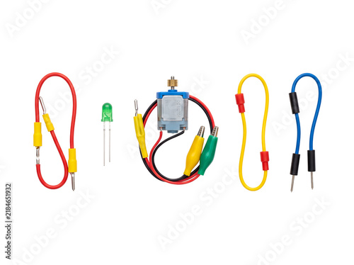 Electric DC motor jumper wires LED light electronic circuit components set isolated on black background for STEM science education physics experiments DIY kit prototype prototyping project hardware.