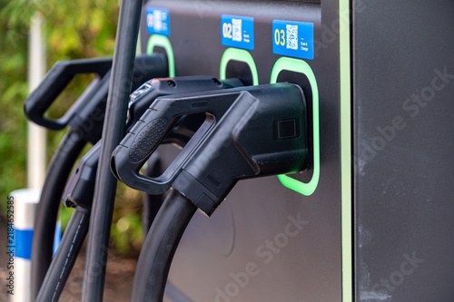 Electric car charging station with multiple connectors in a public area
