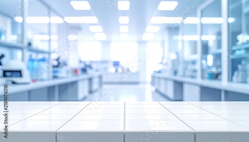 Out of focus contemporary laboratory room with clean white table foreground, glass partitions, shelves, scientific instruments and bright blue background