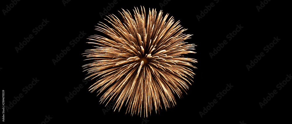 Fototapeta premium Golden firework burst isolated on a black background. Explosion with sparkling glitter light rays. Single glowing pyrotechnic explosion for celebration and New Year events.