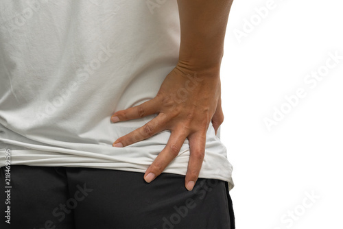 Back pain with a hand pressing the lower back and hip area to illustrate lumbar discomfort and musculoskeletal symptoms for medical treatment.