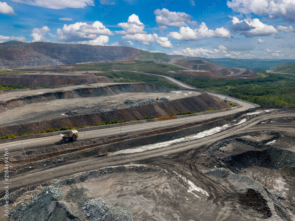 Obraz premium Open pit mine industry, big yellow mining truck for gold, copper ore, aerial view
