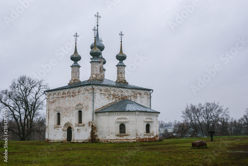 Canvas Print A historic Russian Orthodox church with onion domes in a rural landscape on an overcast day