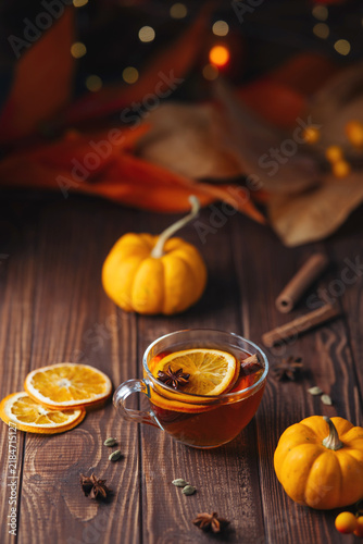 Autumn tea with orange cinnamon and star anise on a rustic wooden table