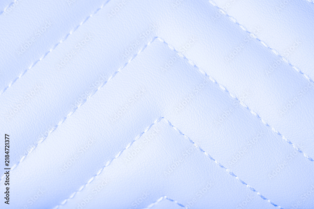Naklejka premium Soft light blue quilted leather texture featuring white stitched chevron pattern background surface detail