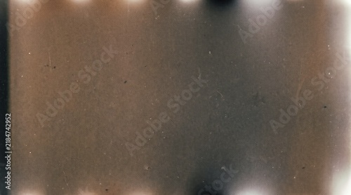 Fotografie Vintage film grain texture with light leaks and scratches in warm sepia tones
