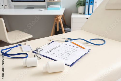 Calendar with doctors supplies on couch in medical office, closeup