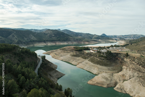 Aerial view of Iznajar Reservoir surrounded by olive groves and mountains in Andalusia, Spain