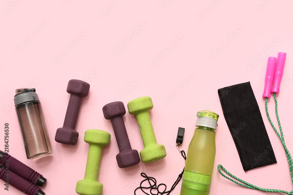 Obraz premium Headband, whistle and different sports equipment on pink background