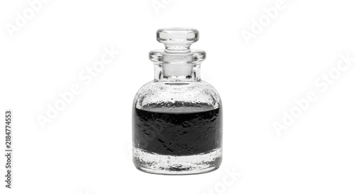 Foto Antique glass bottle filled with dark liquid and stopper