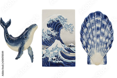 Ceramic whale figurine, wave tile, and scallop shell dish with blue and white glazed patterns isolated on a transparent background