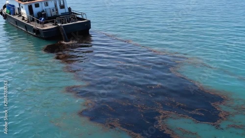 Oil spill from a ship into the sea.