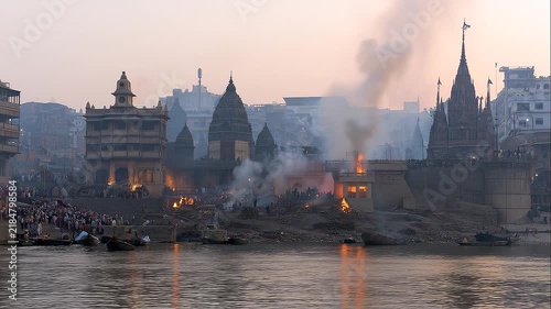 Wide elevated view of thousands of pilgrims gathering at historic riverfront ghats during Maha Kumbh Mela, performing sacred bathing rituals in the holy river in India.