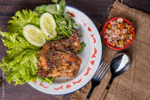 Принти на полотні Grilled *Tuwuk* free-range chicken—accompanied by lettuce, cucumber, and watercress—is plated and photographed against a gray background