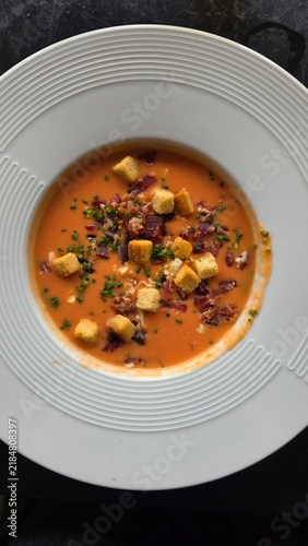 Traditional Spanish salmorejo tomato soup with croutons and ham