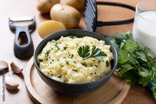 Creamy mashed potatoes on wooden table