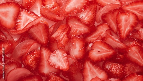 Fresh Strawberries Sliced and Whole in Red Tinted Light