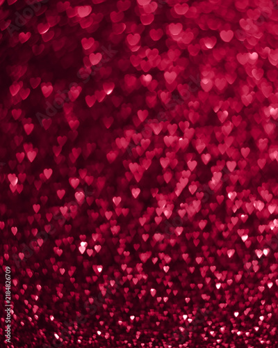 Abstract red heart bokeh glitter background. Beautiful sparkling defocused light, valentine love concept, romantic festive texture backdrop