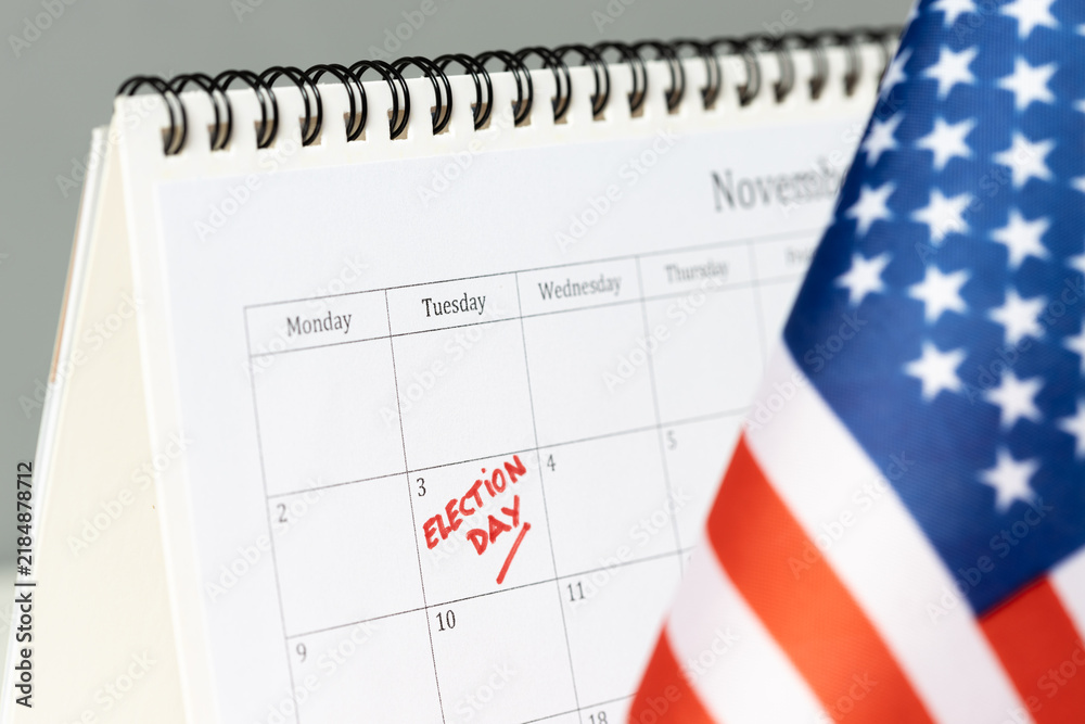 Fototapeta premium Close up of election day marked on calendar with usa flag
