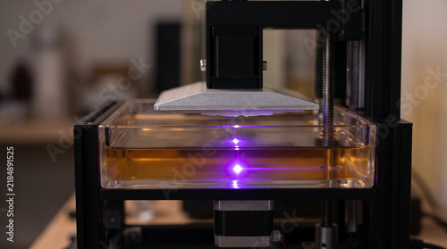 Obraz na płótnie 3D printer curing resin with purple light in laboratory setting