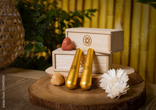 Fotografía Golden Facial Massage Tools and Luxury Wooden Product Boxes with Hearts on Wood