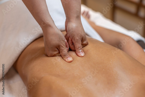 Obraz na plátně Close Up of Therapist Using Thumbs for Deep Tissue Back Massage on Female Client