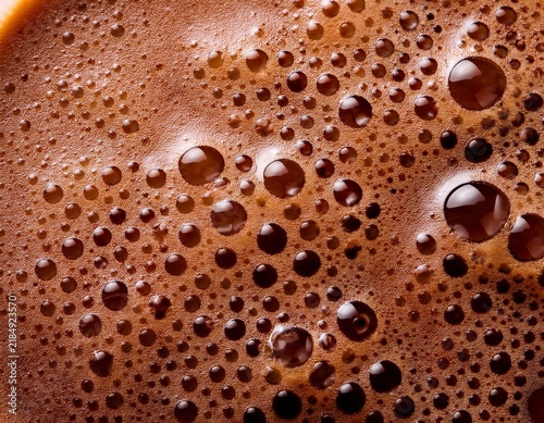 foamy coffee surface close up creamy texture brown bubbles