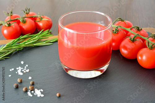 Принти на полотні a glass of Tomato Juice with Cherry Tomatoes and Herbs on Slate Surface