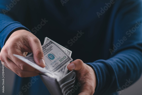 Canvastavla Close-up of a person counting US dollar bills from a wallet, representing cash, personal finance, income, savings, budgeting, payment, wealth management, and everyday financial planning