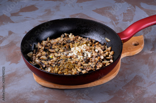 Finely chop the mushrooms, onions, and garlic and fry them in a pan with spices and salt. Prepare the base for the filling, julienne, or sauce
