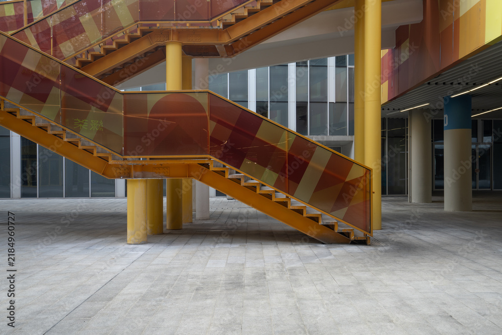 Obraz premium colorful glass staircase in modern building interior