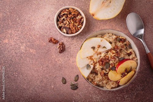Autumn oats porridge bowl apple pear walnuts top view healthy fiber ccopy space