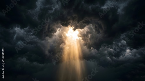 Bright golden sunlight breaking through dark stormy clouds illustrating a sudden shift in severe weather conditions and natural climate contrast