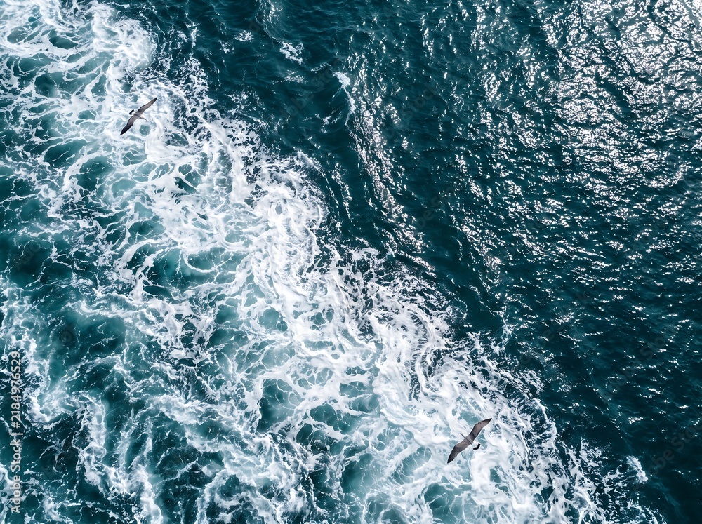 Fototapeta premium Ocean water wake and foaming white waves churning behind a moving boat with navigation turbulence abstract background sunlight reflection