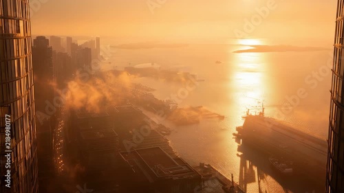 High angle view of city harbor covered in fog during golden sunset cinematic