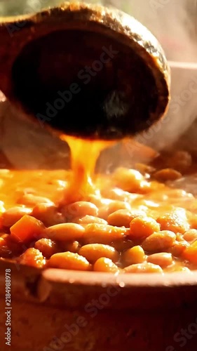 Close up of delicious homemade African food spicy stew simmering in a clay bowl with rising steam