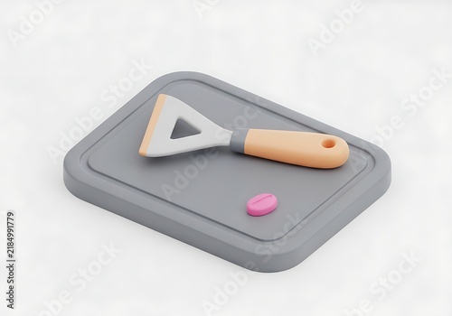 Spreader tool with spatula and pink pill on gray base