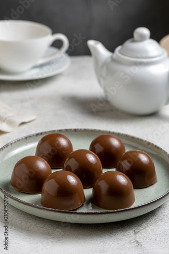 Gourmet Milk Chocolate Bonbons and Chocolate Truffles on Ceramic Plate